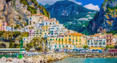 Wonderful Italy. The small haven of Amalfi village with a turquoise sea and colorful houses on the slopes of the coast.